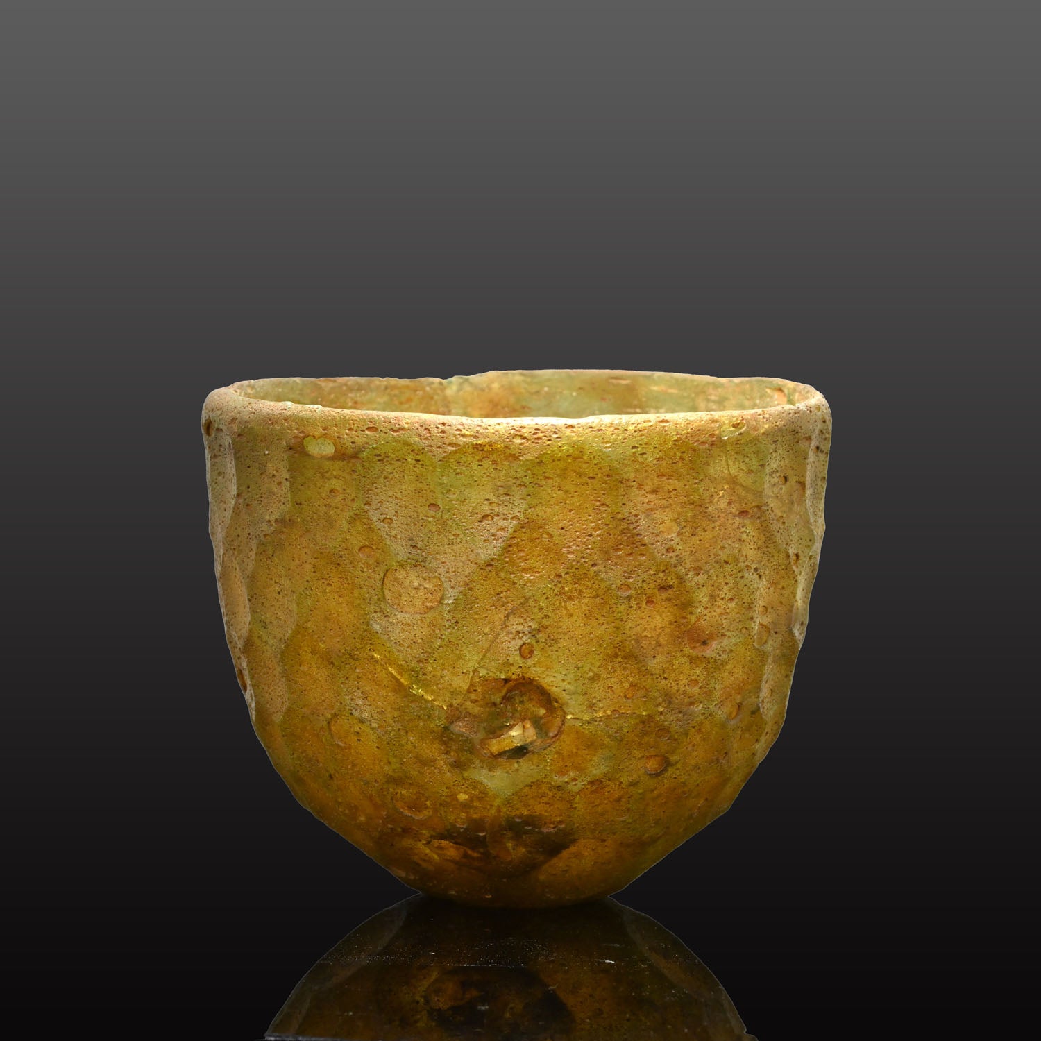 A Sasanian Green Cut-Glass Bowl with Hexagonal Facets, ca. 5th - 6th century CE