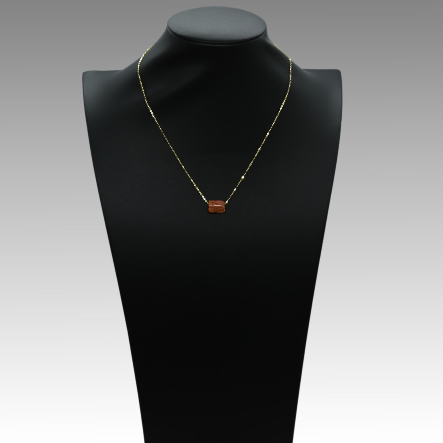 An Egyptian Carnelian Wedjat eye Pendant, New Kingdom, 18th - 19th Dynasty, ca. 1550 - 1290 BCE