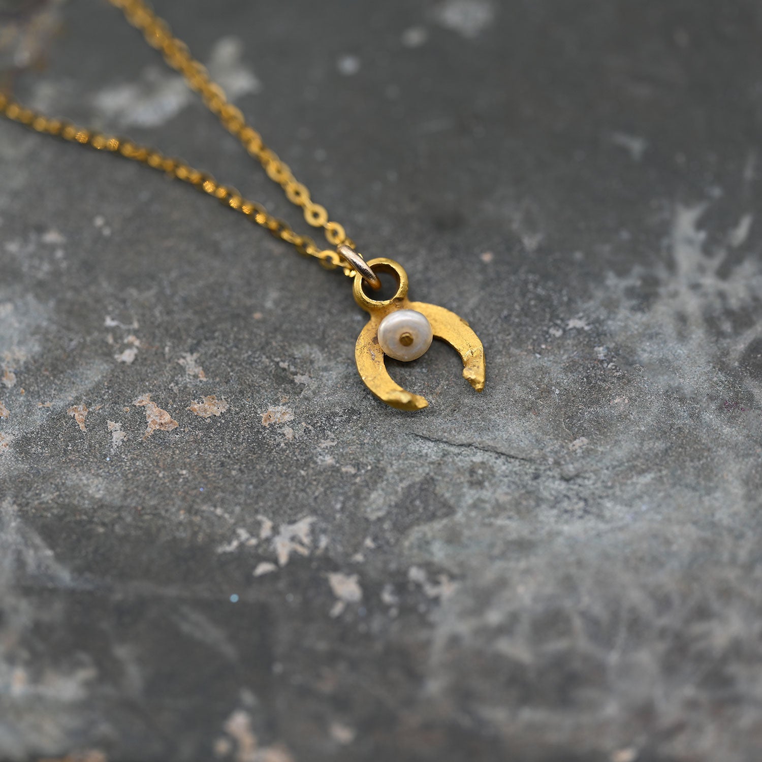 A tiny Roman Gold and Pearl Luna Pendant, Roman Imperial Period, ca. 1st - 2nd century CE