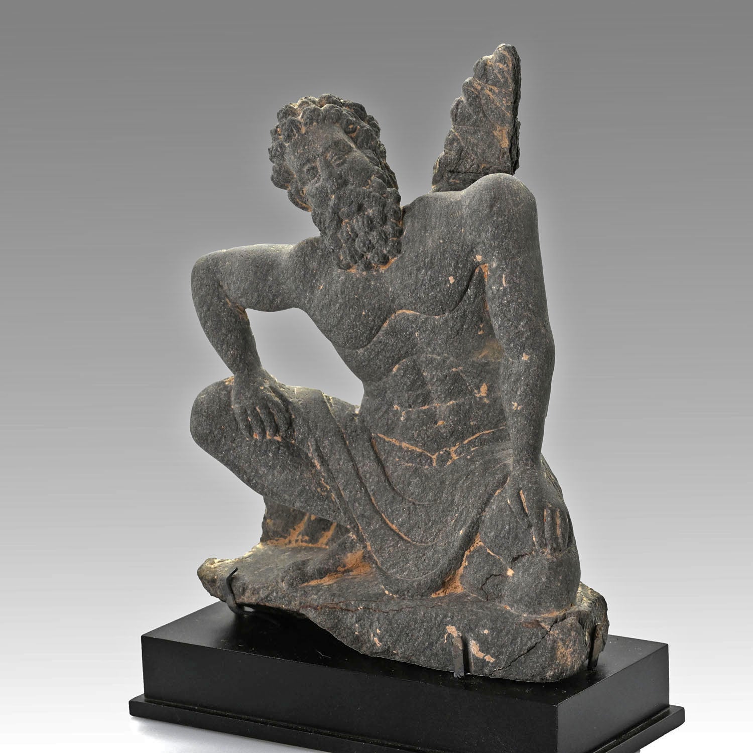 A Gandharian Gray Schist Figure of a Kneeling Atlas, ca. 2nd - 4th century CE