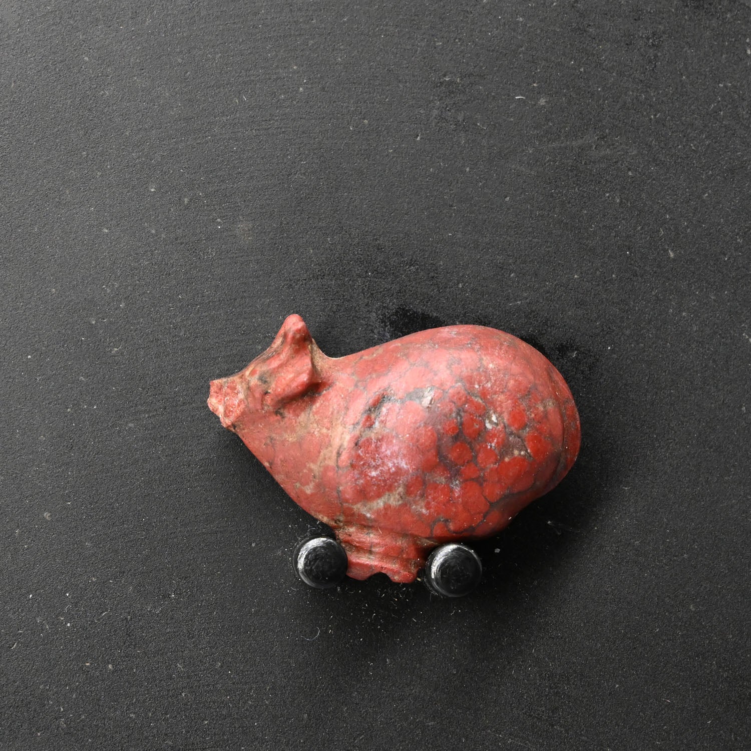 An Egyptian Red Jasper Trussed Ox Amulet, New Kingdom, ca. 1550 - 1069 BCE