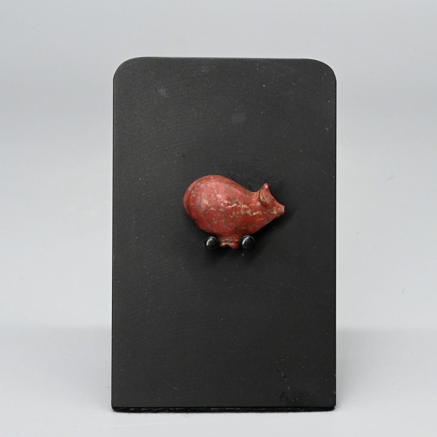 An Egyptian Red Jasper Trussed Ox Amulet, New Kingdom, ca. 1550 - 1069 BCE