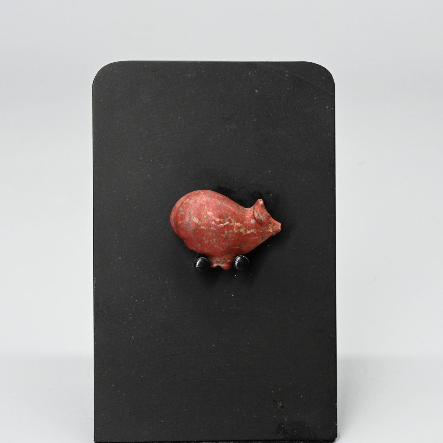 An Egyptian Red Jasper Trussed Ox Amulet, New Kingdom, ca. 1550 - 1069 BCE