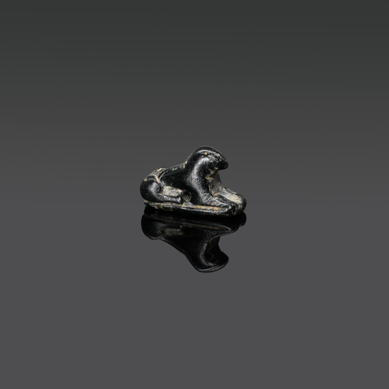 An Egyptian Serpentine Inscribed Scaraboid of a Recumbent Ram, 18th Dynasty, ca. 1550 - 1295 BCE