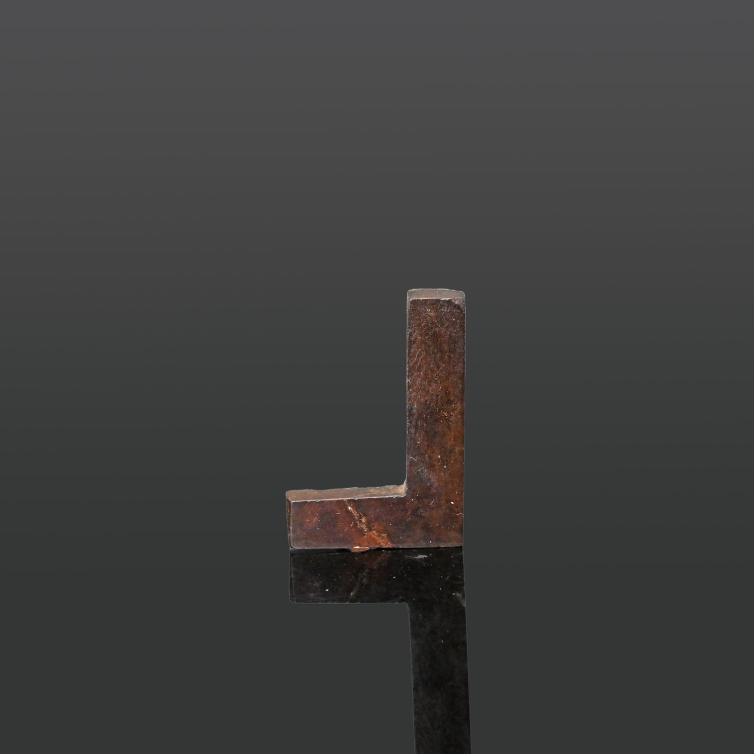 An Egyptian Hematite Set Square Amulet, Late Period, ca. 664 - 332 BCE