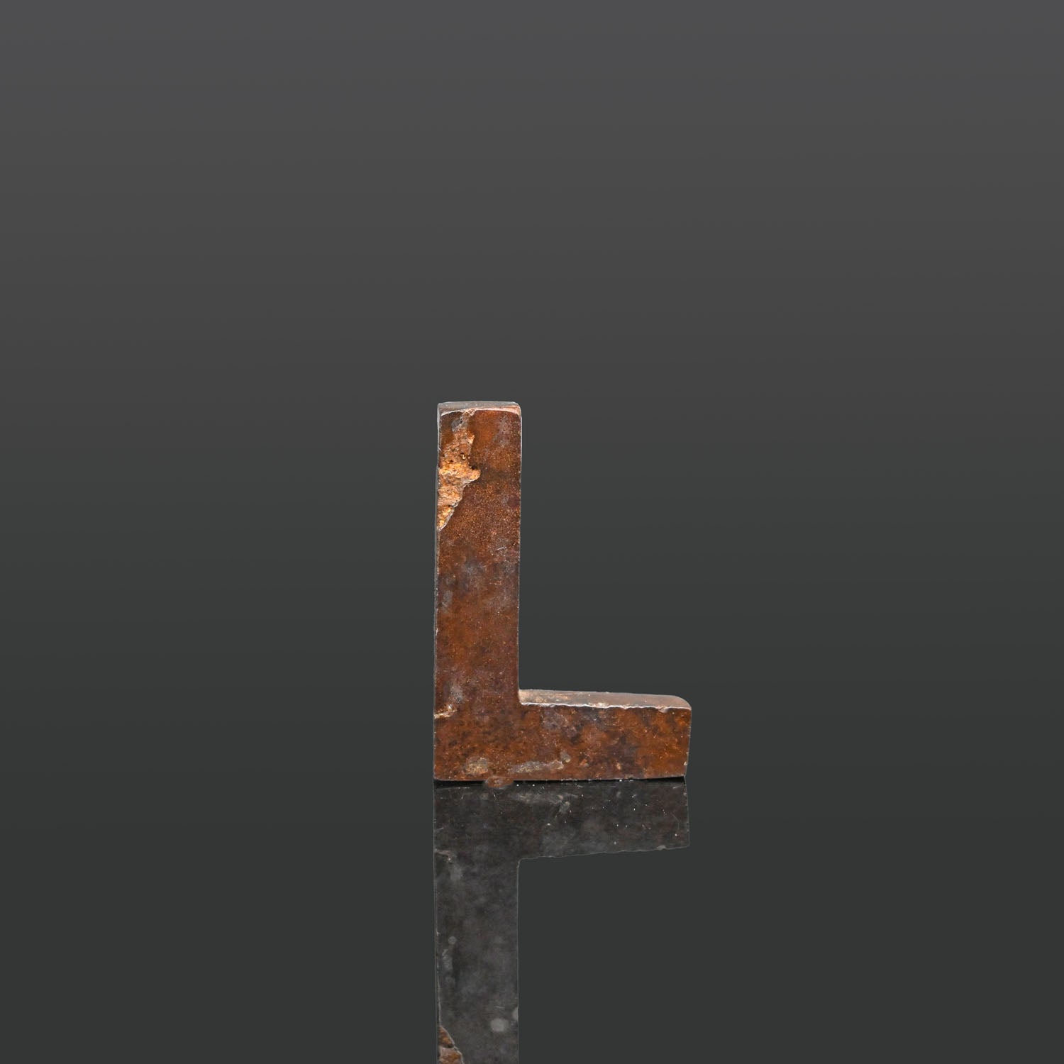 An Egyptian Hematite Set Square Amulet, Late Period, ca. 664 - 332 BCE