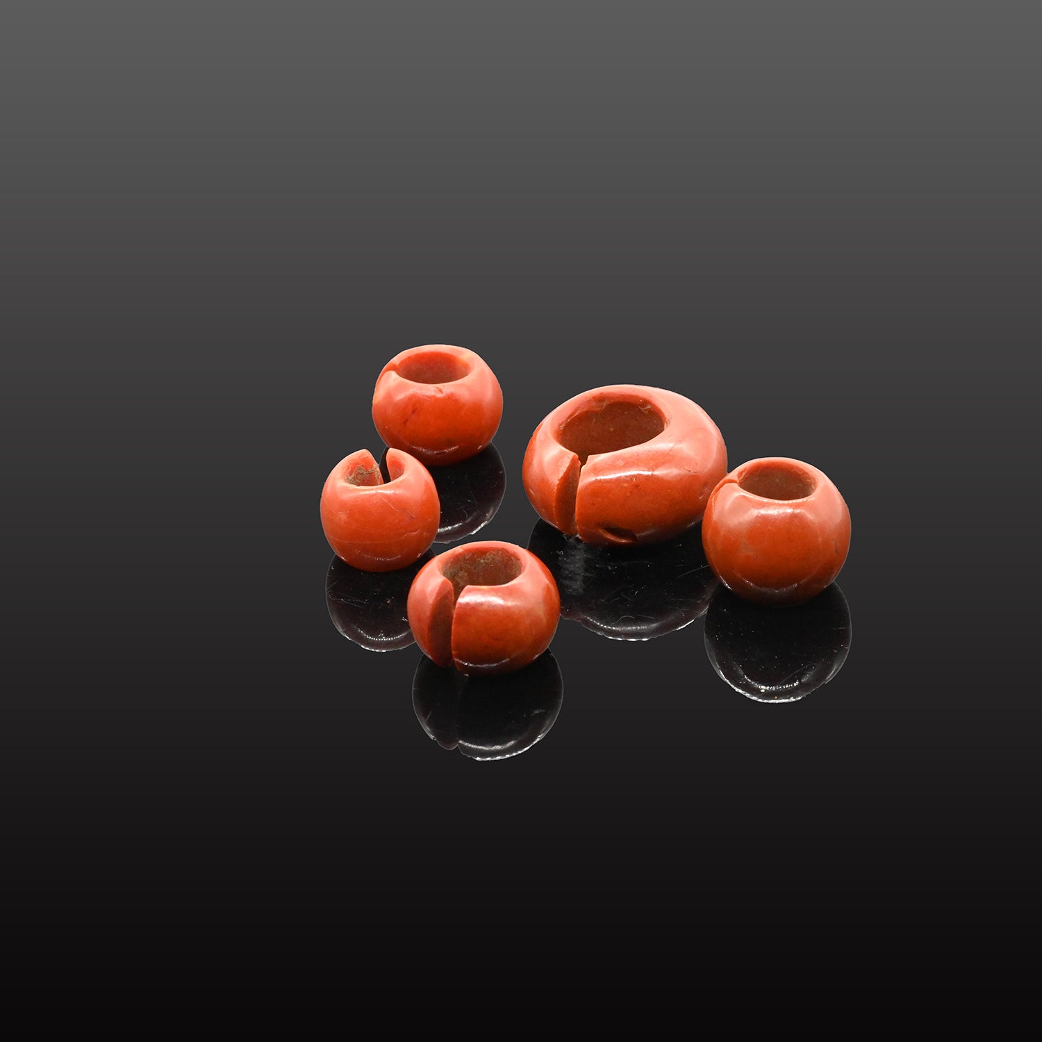 Group of five Egyptian Red Glass Penannular Earrings and Hair Rings, New Kingdom, 18th Dynasty, 1550-1295 BCE