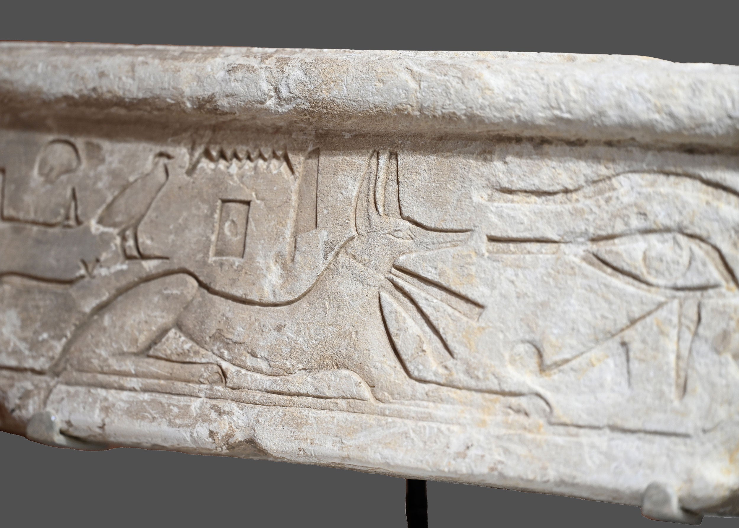 An Egyptian Limestone Relief fragment with Wedjet Eye and Anubis, New Kingdom, 18th Dynasty, ca. 1540 - 1292 BCE