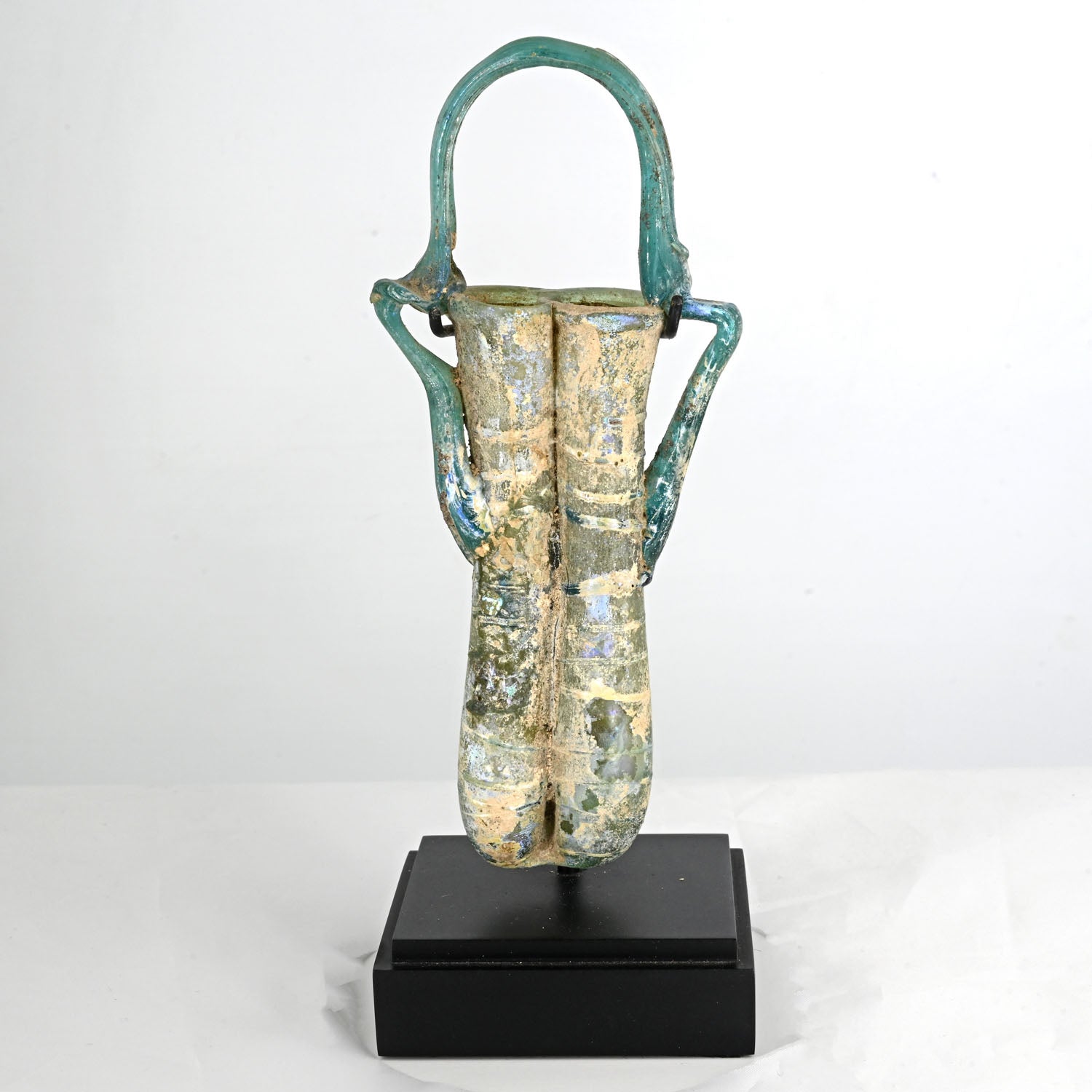 A Roman glass double balsamarium with handle, Roman Imperial Period, ca. 4th century CE