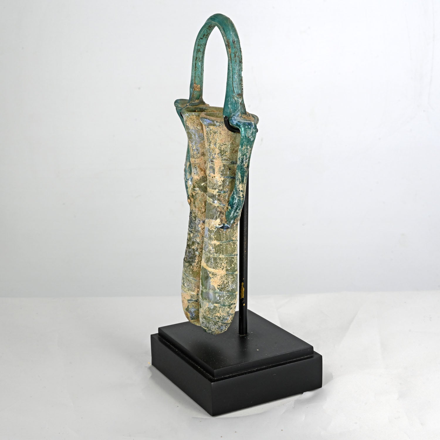 A Roman glass double balsamarium with handle, Roman Imperial Period, ca. 4th century CE