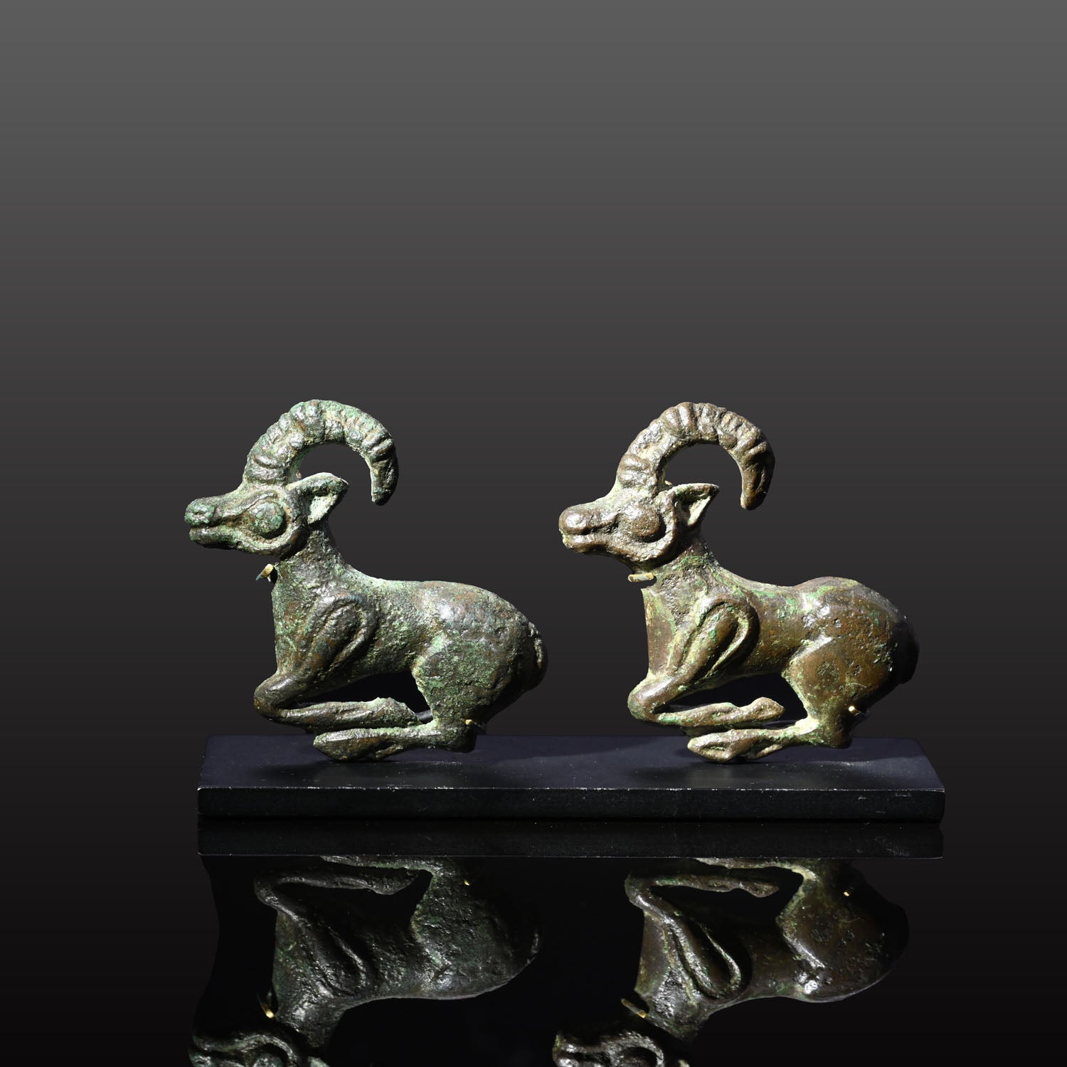 A fine published Pair of Eurasian Bronze Ibex Appliques, ca. 4th century BCE