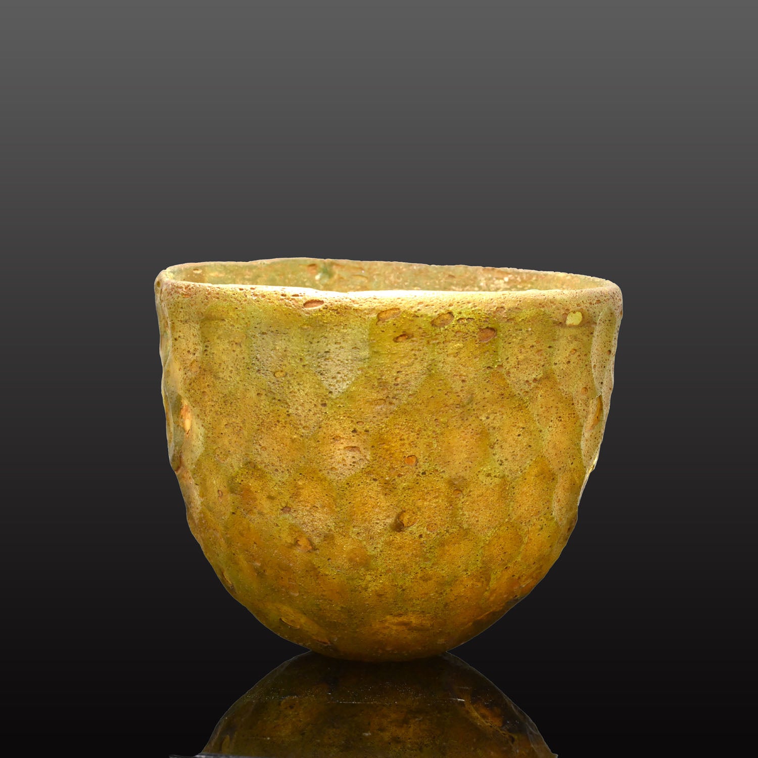 A Sasanian Green Cut-Glass Bowl with Hexagonal Facets, ca. 5th - 6th century CE