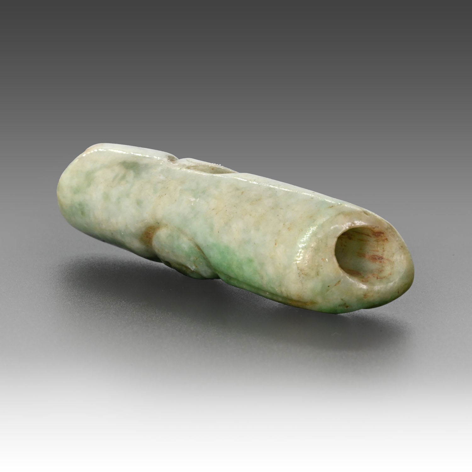 A published Maya Jade Alligator Head Bead, Late Classic Period, ca. 550 - 950 CE