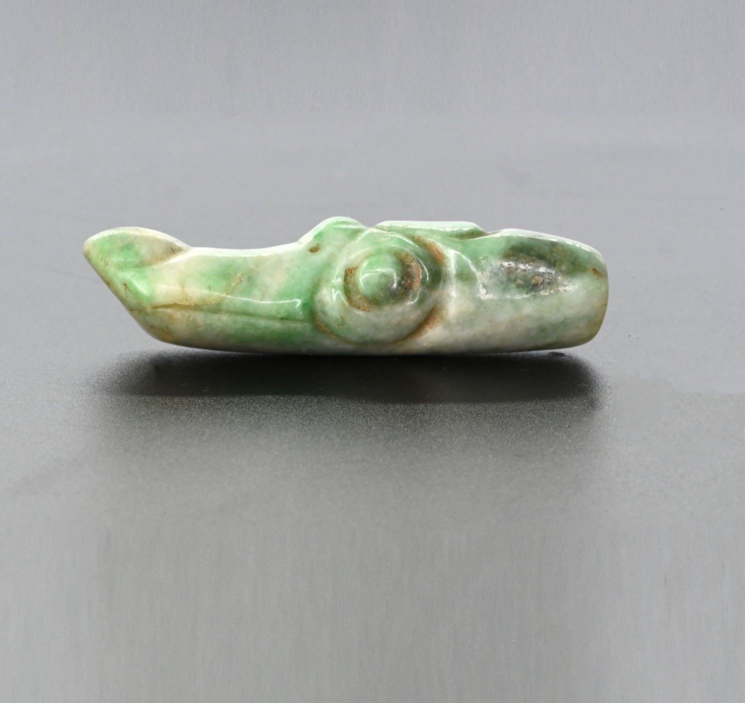 A published Maya Jade Alligator Head Bead, Late Classic Period, ca. 550 - 950 CE