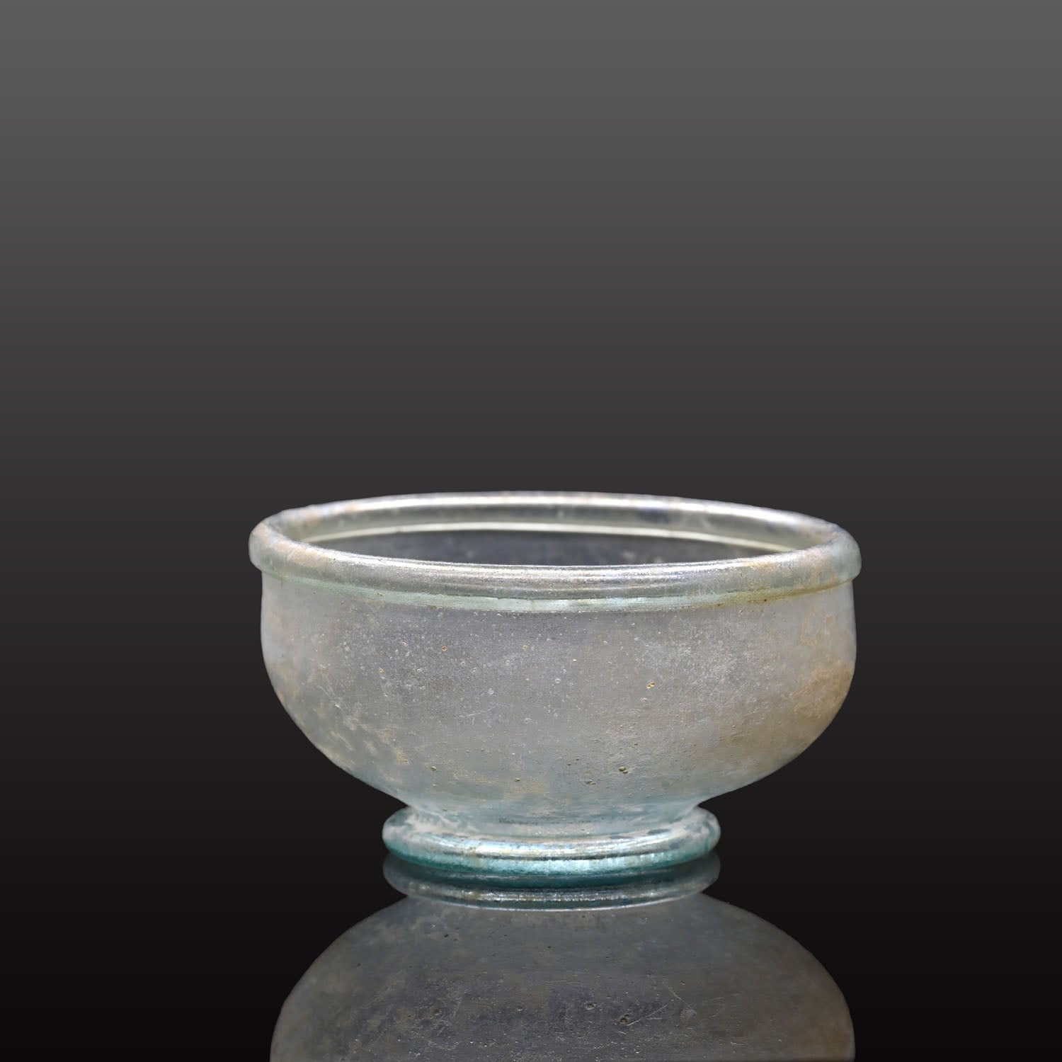 A small Roman Blue-Green Glass Bowl with Foot, Roman Imperial Period, ca. 3rd century CE
