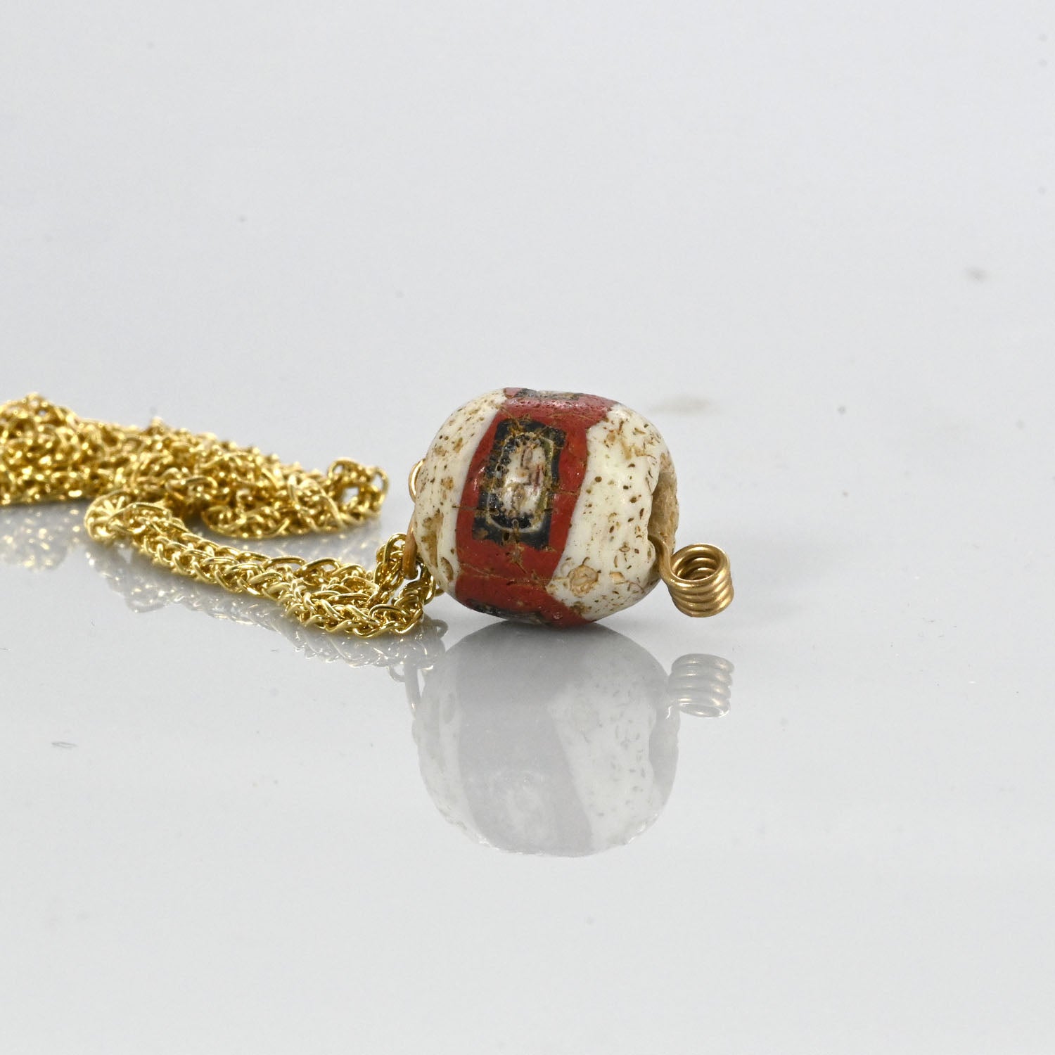 A fine Roman Glass Portrait Head Bead, Roman Imperial Period, ca. 100 - 200 CE