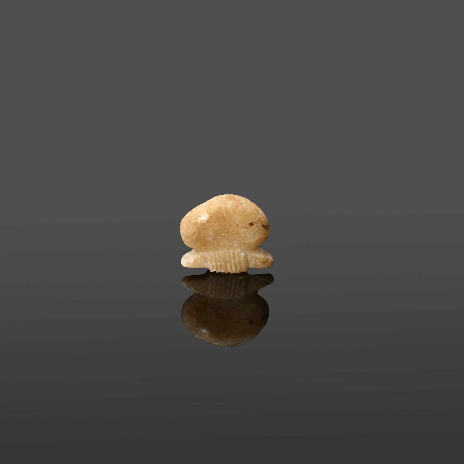 An Egyptian Alabaster Sun Disc Amulet, Late Period, ca. 664 - 332 BCE