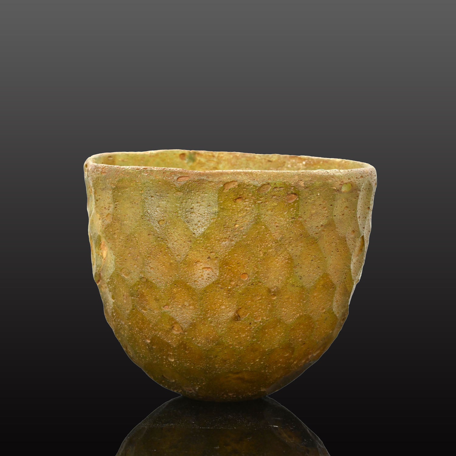 A Sasanian Green Cut-Glass Bowl with Hexagonal Facets, ca. 5th - 6th century CE