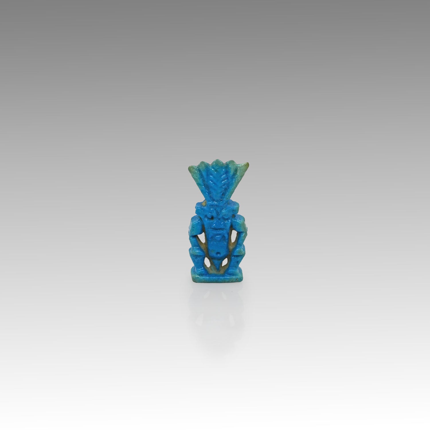 An Egyptian bright blue faience Bes amulet, New Kingdom, 1539-1077 BCE
