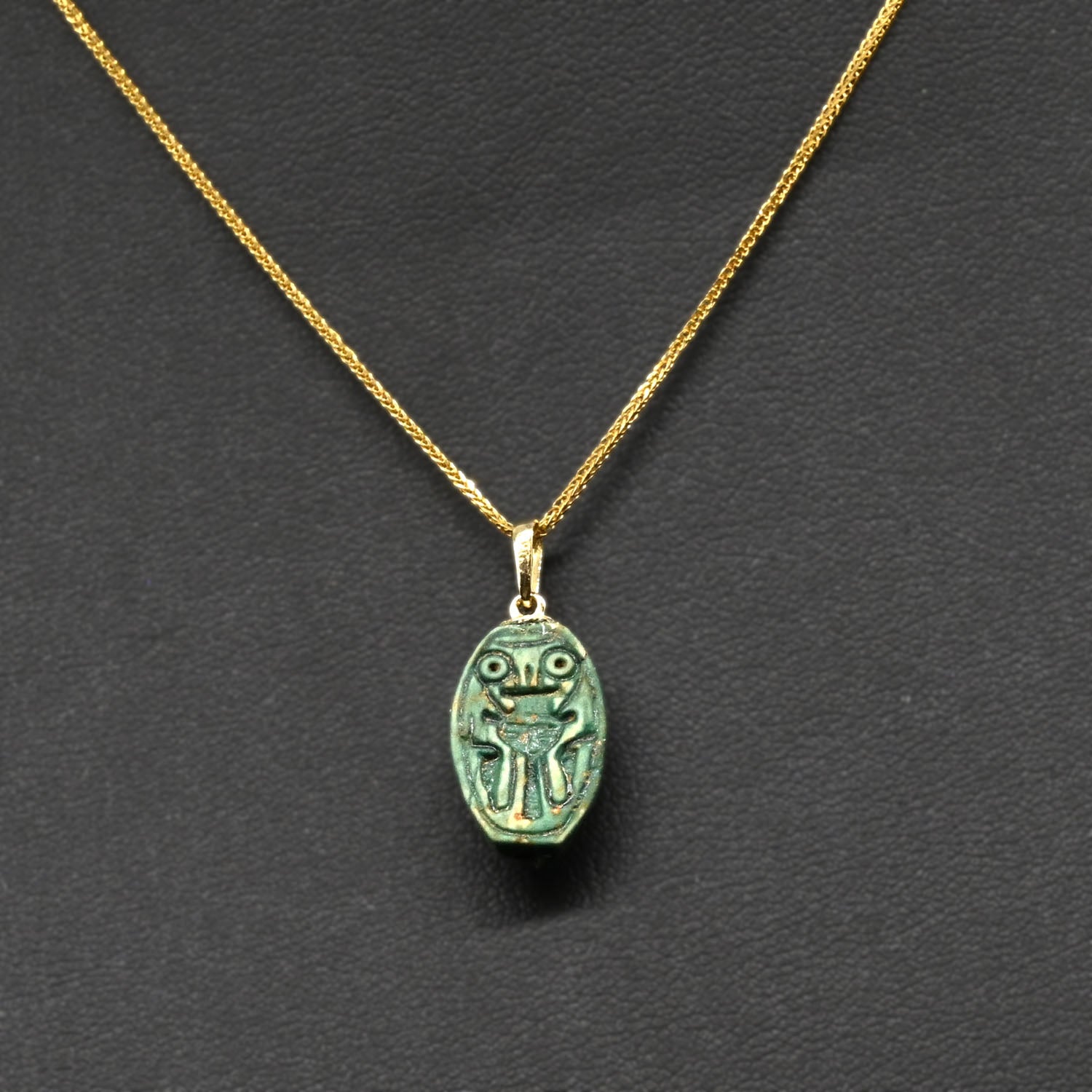 An Egyptian Green Glazed Hathor Scaraboid, New Kingdom, 18th - 19th Dynasty, ca 1550-1290 BCE