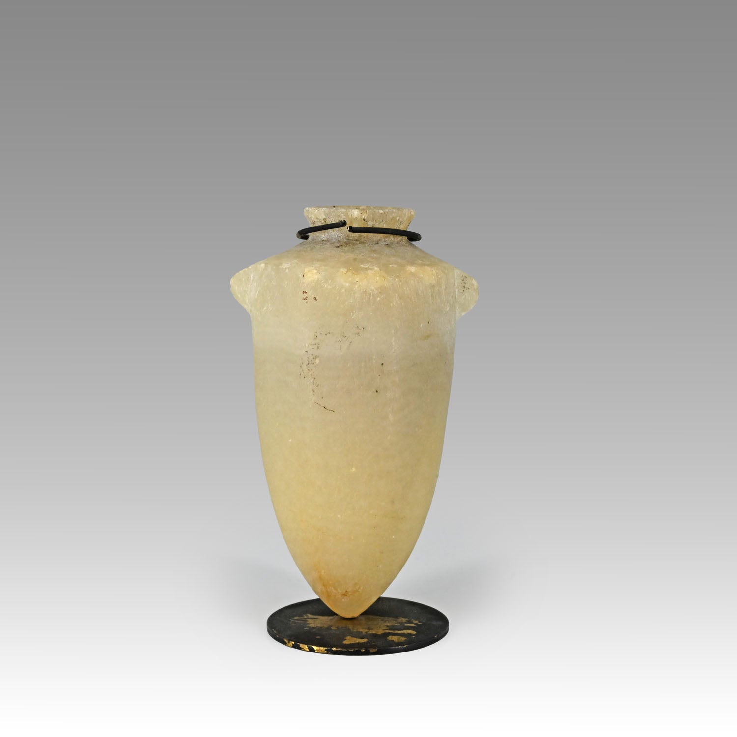 An Egyptian pointed-base alabastron, New Kingdom, ca. 1570 - 1070