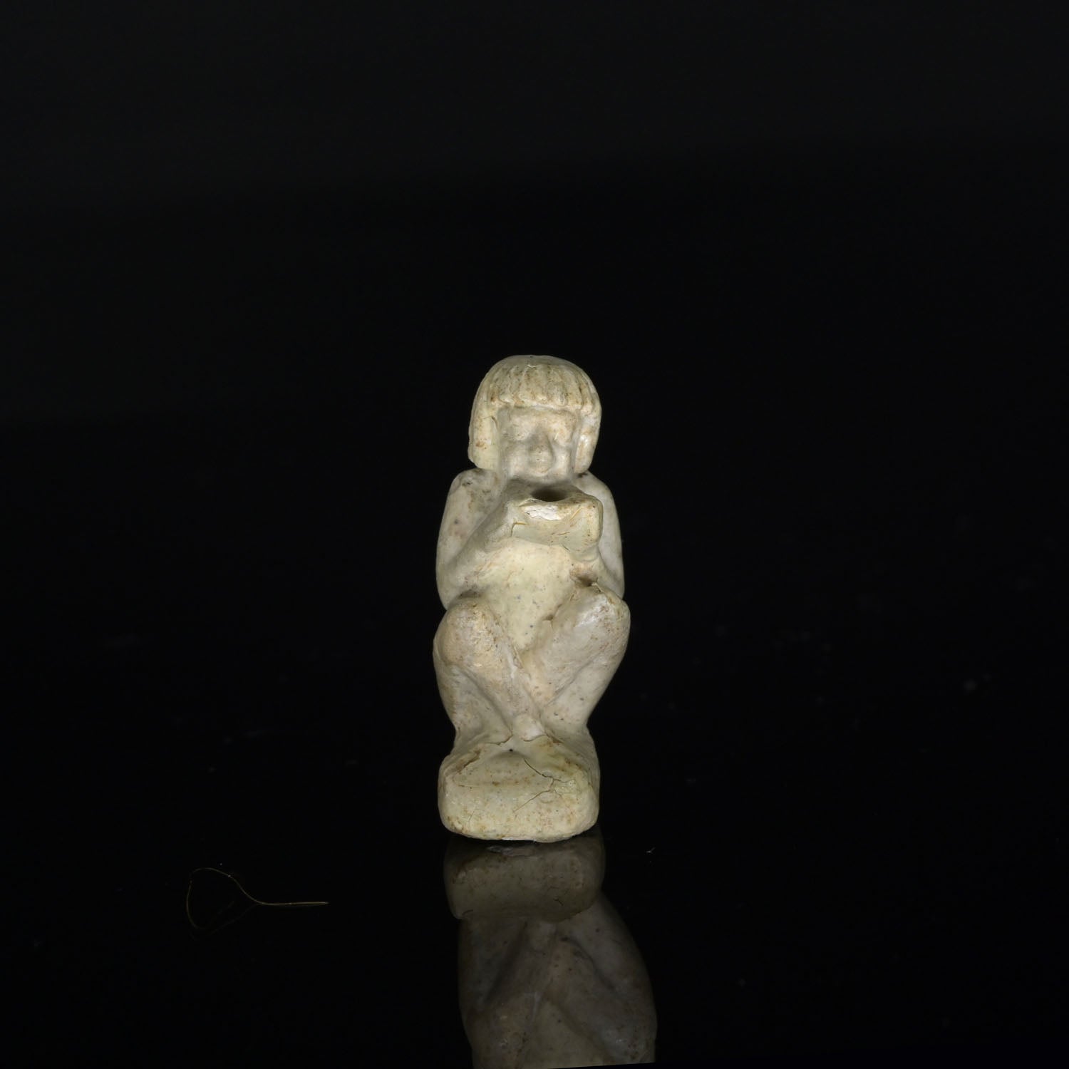 An Egyptian Faience Amulet of a Supplicant, Late Period, ca. 664 - 332 BCE