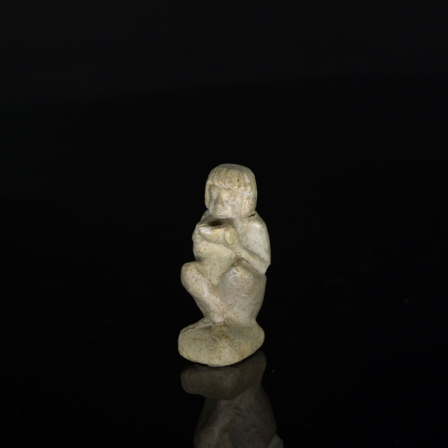 An Egyptian Faience Amulet of a Supplicant, Late Period, ca. 664 - 332 BCE