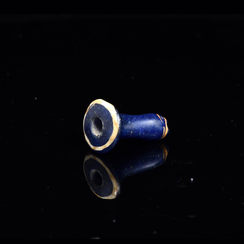 An Egyptian Blue Glass Ear Stud, 18th - 19th Dynasty, ca. 1350 - 1250 BCE