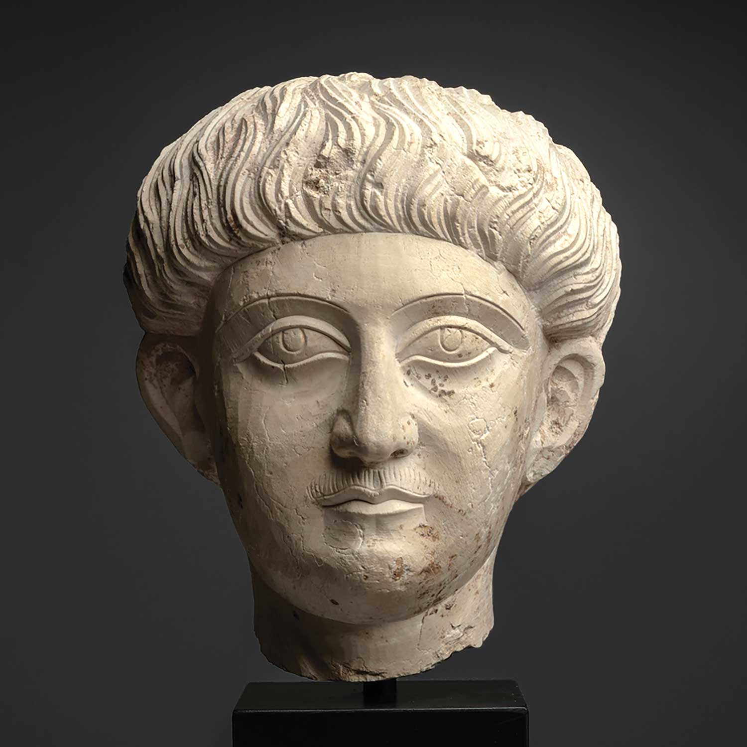 A good Palmyrene Limestone Portrait Head of a Youth ca. 2nd - 3rd century CE
