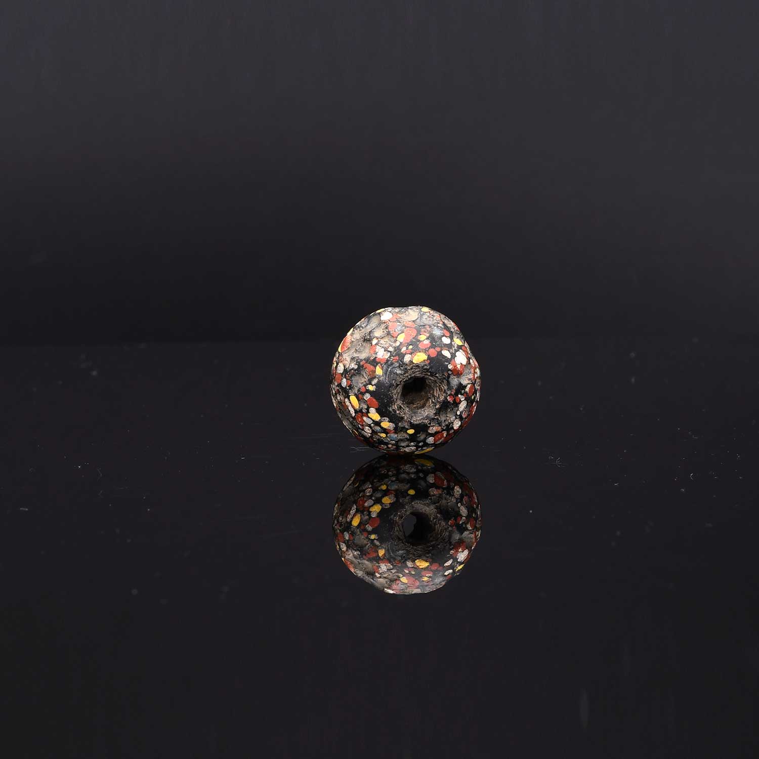 A Large Roman Glass Crumb Bead, Late Roman Imperial Period, ca. 3rd - 5th century CE