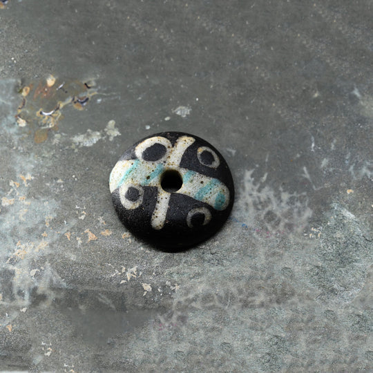 A Roman Decorated Glass Spindle Whorl,  Roman Imperial Period, ca. 2nd - 3rd century CE