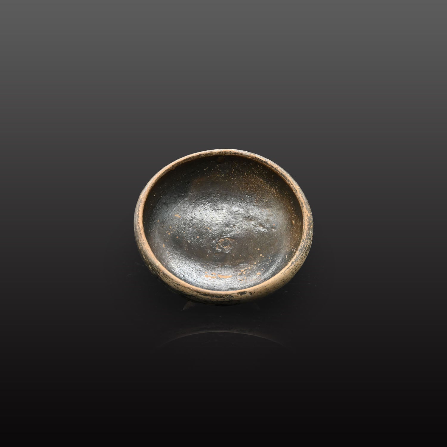 A small Greek Blackware Salt Dish, , ca. 4th century BCE