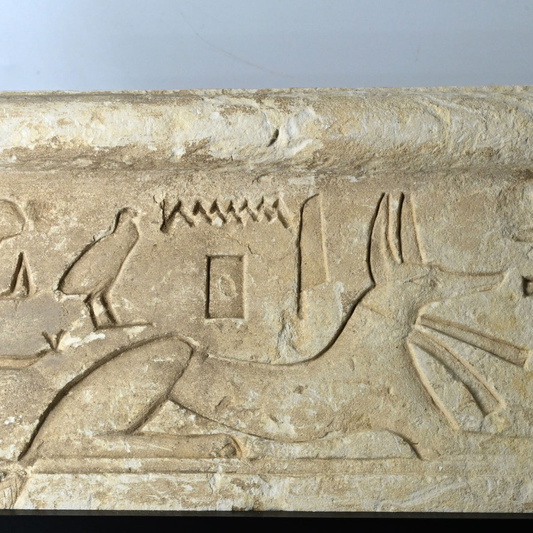 An Egyptian Limestone Relief fragment with Wedjet Eye and Anubis, New Kingdom, 18th Dynasty, ca. 1540 - 1292 BCE