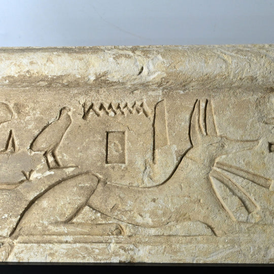An Egyptian Limestone Relief fragment with Wedjet Eye and Anubis, New Kingdom, 18th Dynasty, ca. 1540 - 1292 BCE