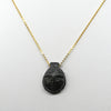 A Coptic Basalt Face Pendant, Coptic Period, ca. 3rd - 7th century CE