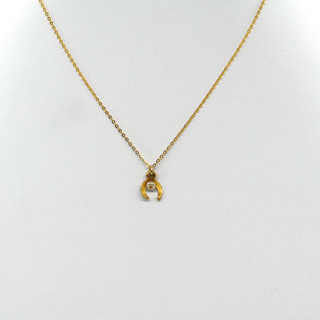 A tiny Roman Gold and Pearl Luna Pendant, Roman Imperial Period, ca. 1st - 2nd century CE