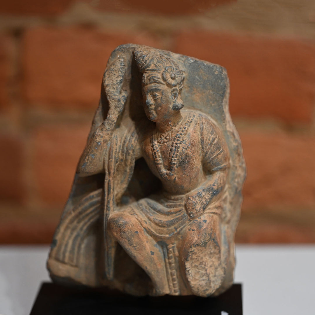 A Gandhara Relief Fragment of a Priestly Attendant, ca. 4th century CE