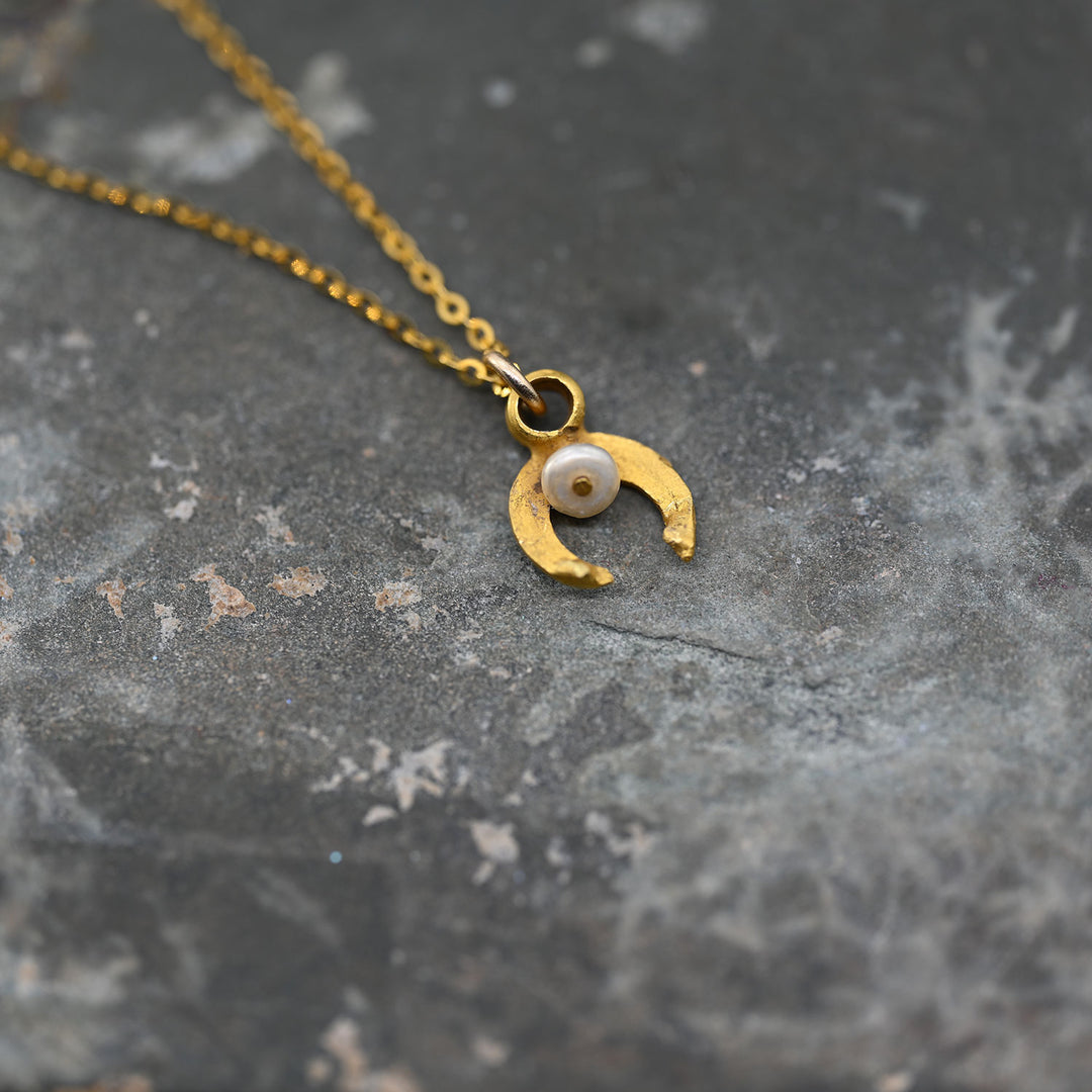 A tiny Roman Gold and Pearl Luna Pendant, Roman Imperial Period, ca. 1st - 2nd century CE