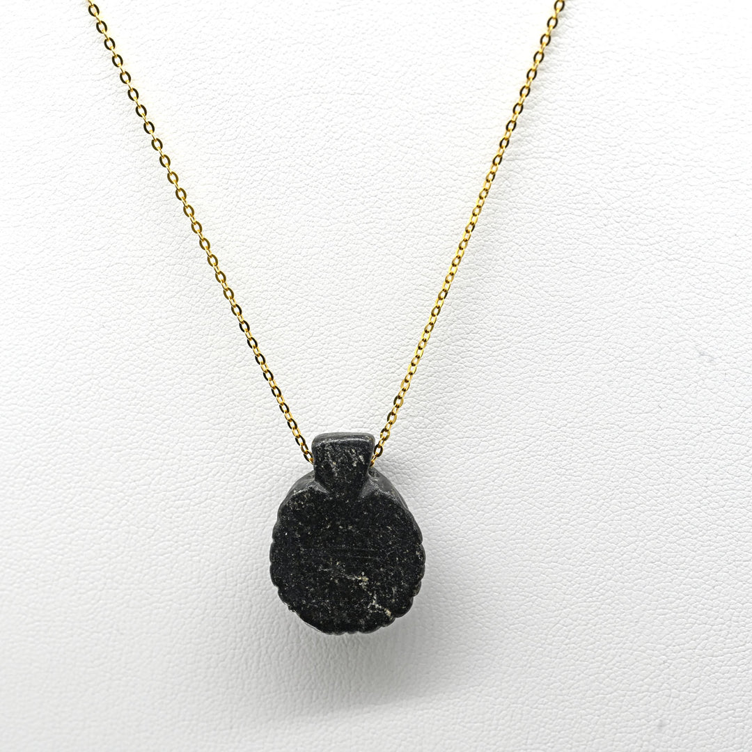 A Coptic Basalt Face Pendant, Coptic Period, ca. 3rd - 7th century CE