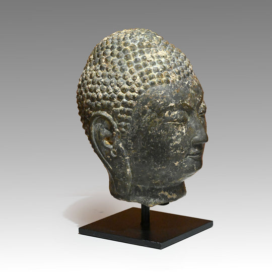 A Chinese Grey Limestone Head of a Buddha, Shandong Province, Northern Qi dynasty, ca. 550 - 577 CE