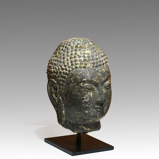 A Chinese Grey Limestone Head of a Buddha, Shandong Province, Northern Qi dynasty, ca. 550 - 577 CE