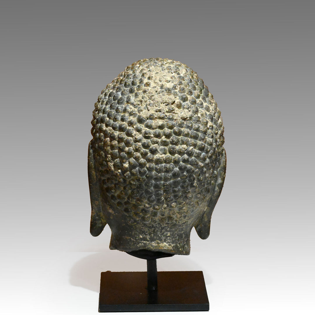 A Chinese Grey Limestone Head of a Buddha, Shandong Province, Northern Qi dynasty, ca. 550 - 577 CE