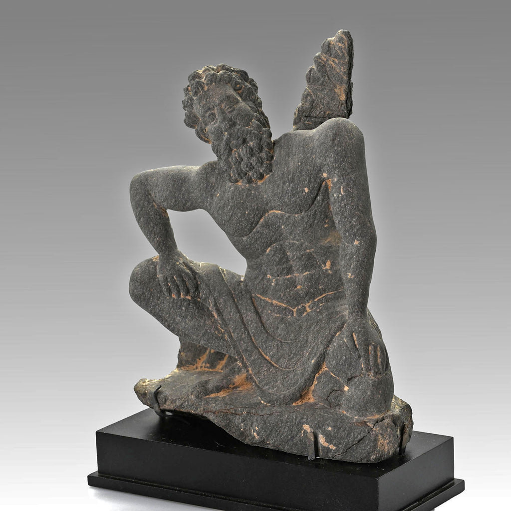 A Gandharian Gray Schist Figure of a Kneeling Atlas, ca. 2nd - 4th century CE