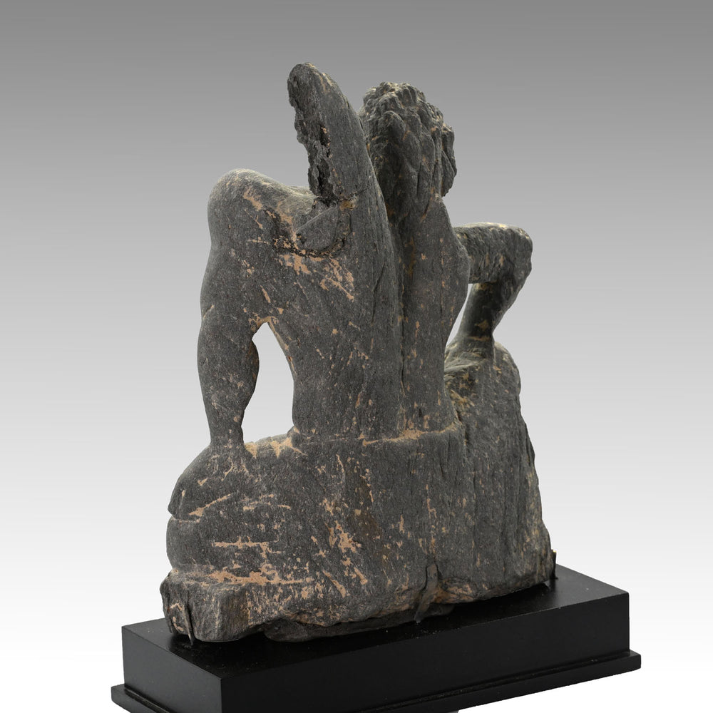 A Gandharian Gray Schist Figure of a Kneeling Atlas, ca. 2nd - 4th century CE