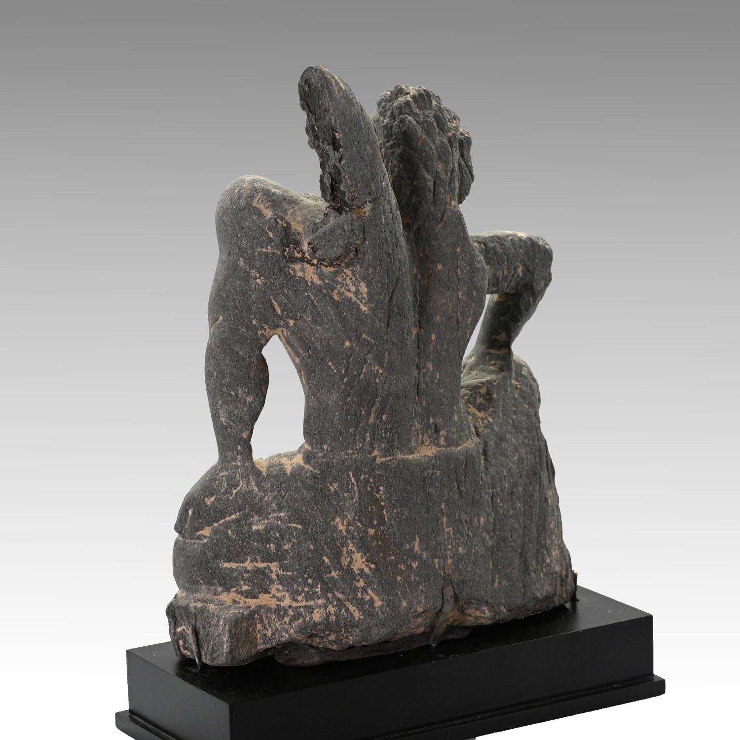 A Gandharian Gray Schist Figure of a Kneeling Atlas, ca. 2nd - 4th century CE