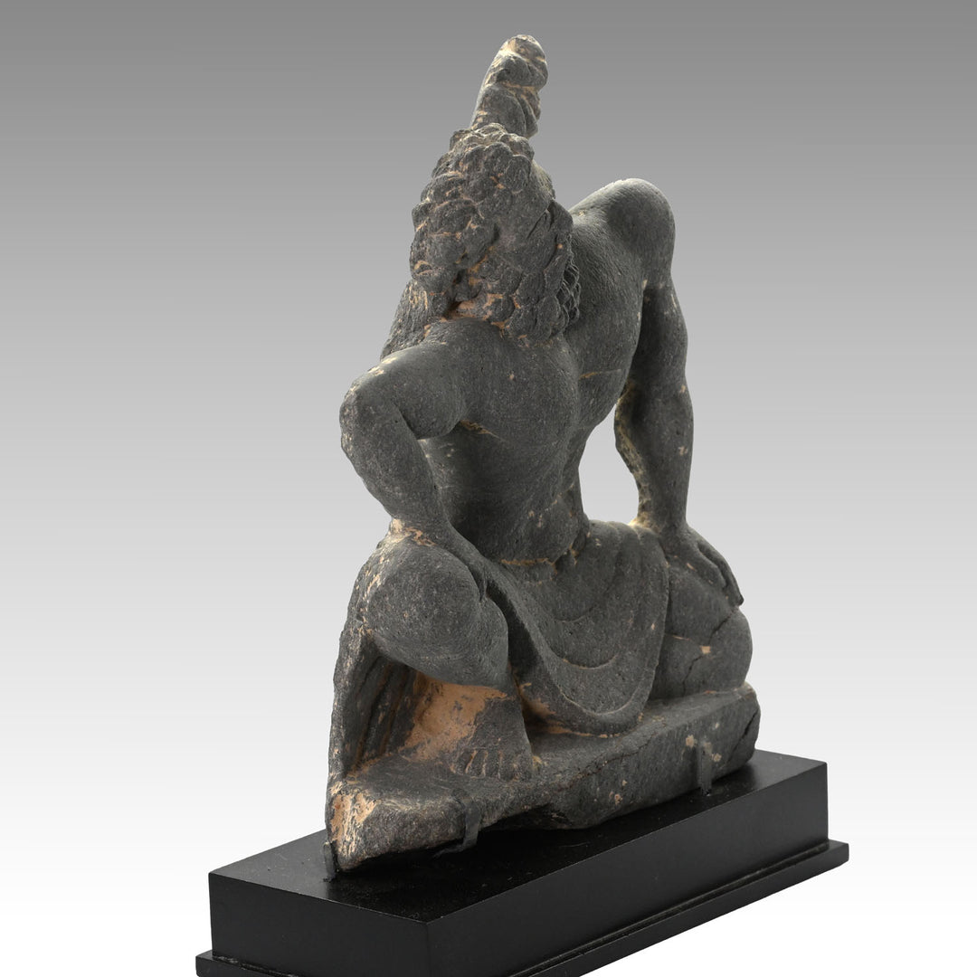A Gandharian Gray Schist Figure of a Kneeling Atlas, ca. 2nd - 4th century CE