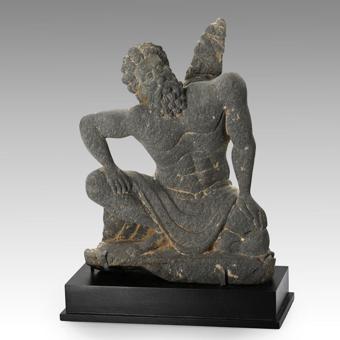 A Gandharian Gray Schist Figure of a Kneeling Atlas, ca. 2nd - 4th century CE