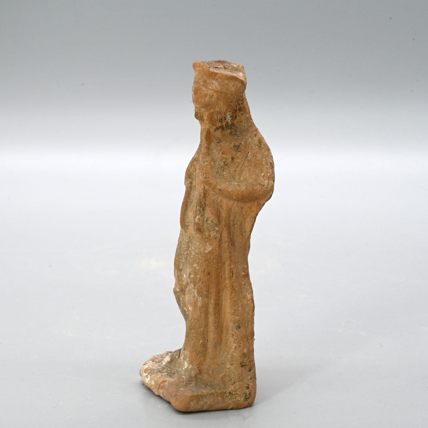 An Attic terracotta figurine of a Girl playing Auloi (double pipes)<br><em>Tanagra, ca. 3rd century BCE</em>