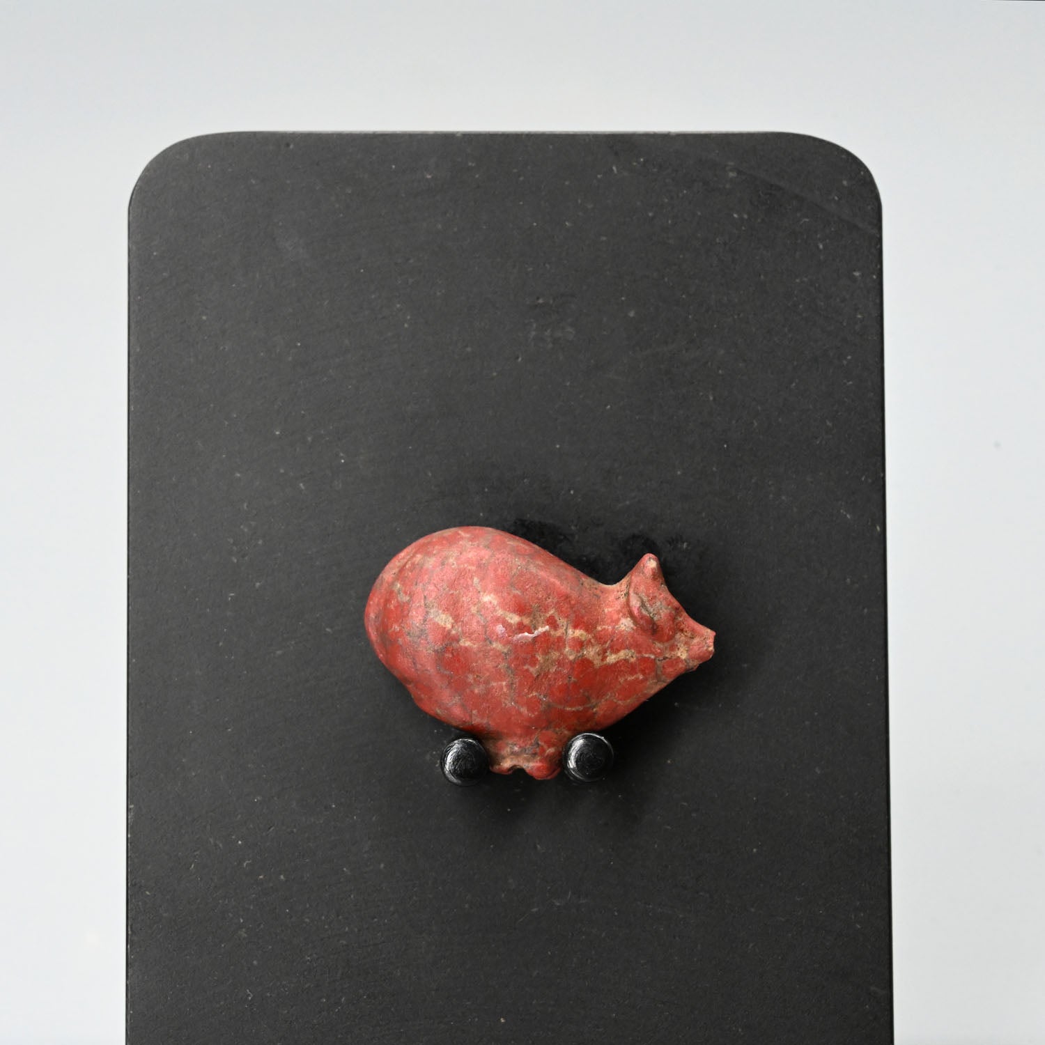 An Egyptian Red Jasper Trussed Ox Amulet, New Kingdom, ca. 1550 - 1069 BCE