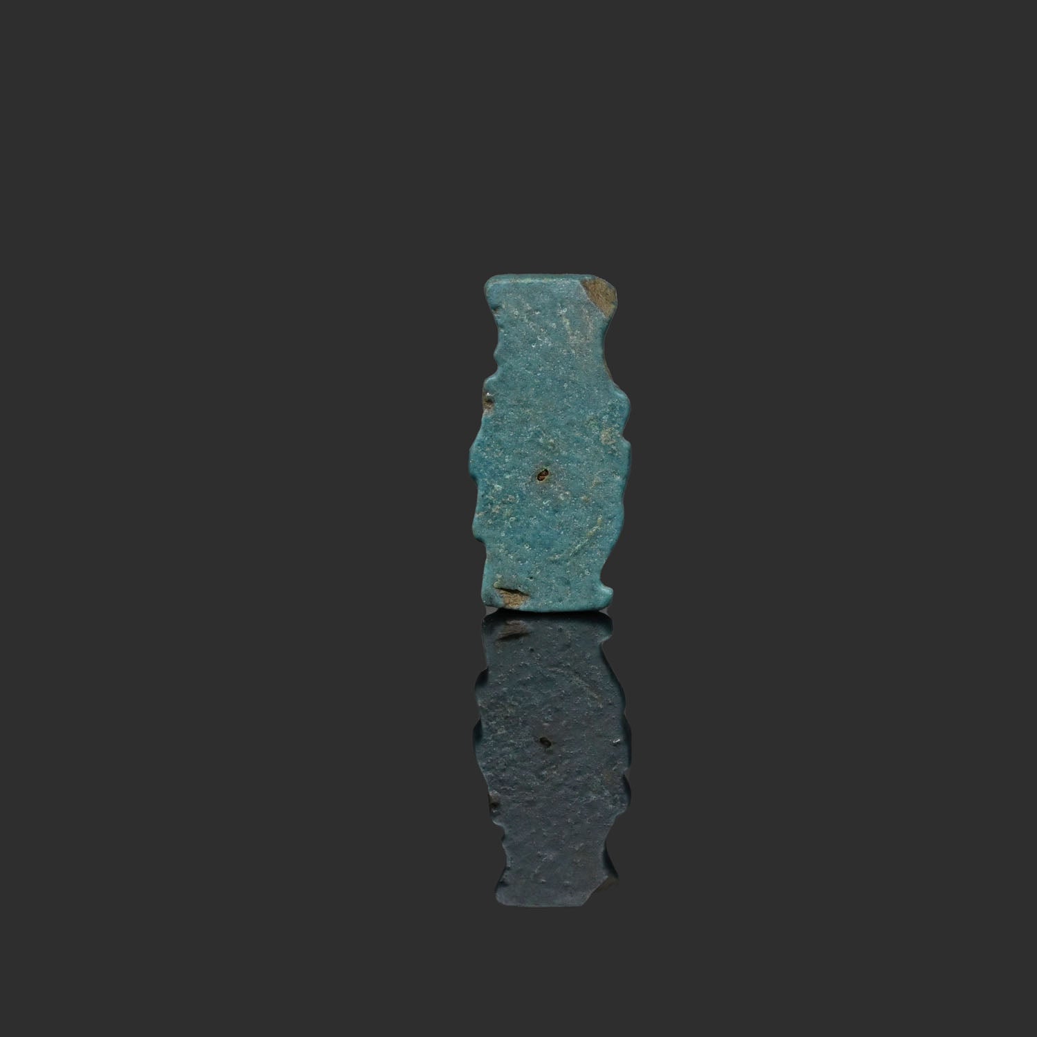 An Egyptian Blue Faience Bes Amulet, Late Period, ca. 664 - 332 BCE